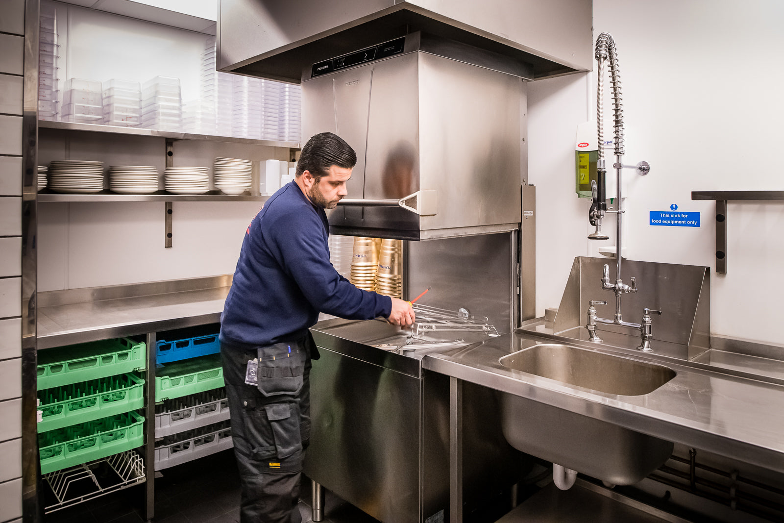 Nelson engineer installing an Advantage commercial dishwasher