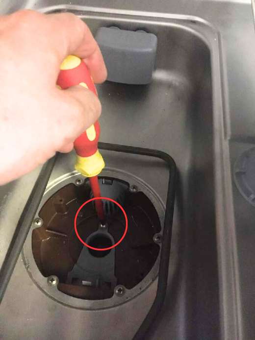 Removing the screw from the drain pump cover